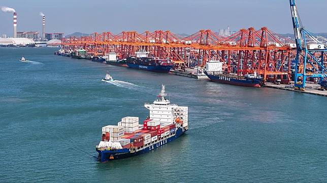 An aerial drone photo taken on Oct. 24, 2024 shows a container ship carrying new energy vehicle (NEV) parts at the Qinzhou Port in Qinzhou, south China's Guangxi Zhuang Autonomous Region. (Xinhua/Zhang Ailin)