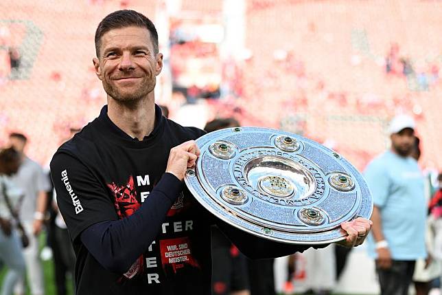 Xabi Alonso, head coach of Bayer Leverkusen, holds the Bundesliga trophy during his side's title celebrations in Leverkusen, Germany, May 18, 2024. (Photo by Ulrich Hufnagel/Xinhua)