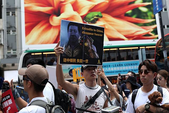 A protester holds up a poster during a march on June 9 against the Hong Kong government’s decision to amend the city’s extradition law to allow the transfer of prisoners to mainland China. Since then, the protests have spiralled into violence. Photo: Xiaomei Chen