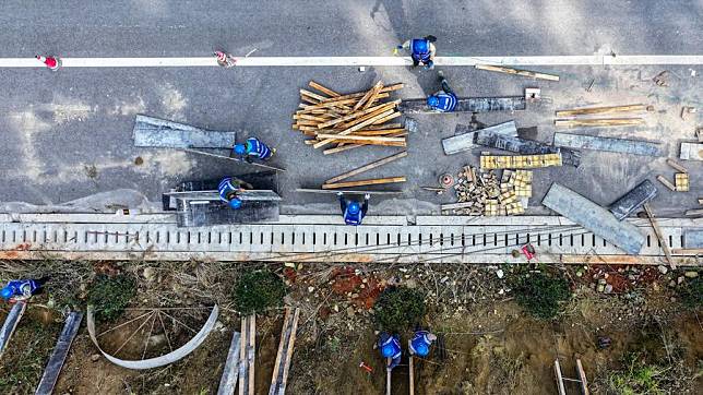 An aerial drone photo shows workers working at the construction site of an expressway in Yiliang County of Kunming, southwest China's Yunnan Province, Dec. 2, 2024. (Photo by Peng Yikai/Xinhua)