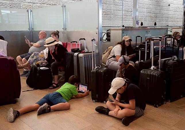 Stranded passengers wait at Ben Gurion International Airport in Tel Aviv, Israel, Aug. 25, 2024. (Xinhua/Chen Junqing)