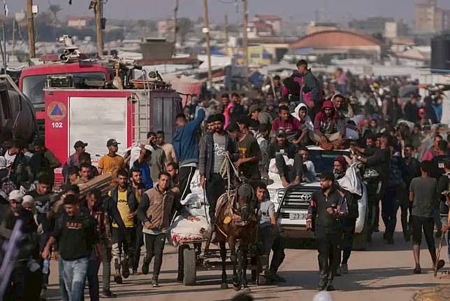 Palestinians carry boxes and bags containing food and humanitarian aid packages delivered by the Gaza Humanitarian Foundation, a U.S.-backed organization approved by Israel, in Khan Younis, southern Gaza Strip, Sunday, June 1, 2025. (AP Photo/Abdel Kareem Hana)