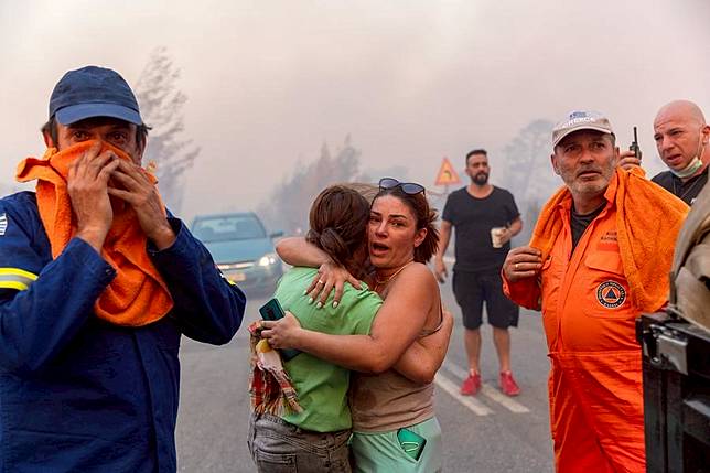 Local residents and firefighters are seen at the site of a wildfire in Varnavas, around 35 km from Athens, Greece, on Aug. 11, 2024. Greek firefighters were battling a major wildfire for several hours on Sunday near Athens. (Xinhua/Marios Lolos)