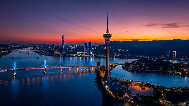 An aerial drone photo taken on July 5, 2024 shows a night view of the Macao Tower (front) in Macao and Zhuhai of Guangdong in south China. (Xinhua/Cheong Kam Ka)