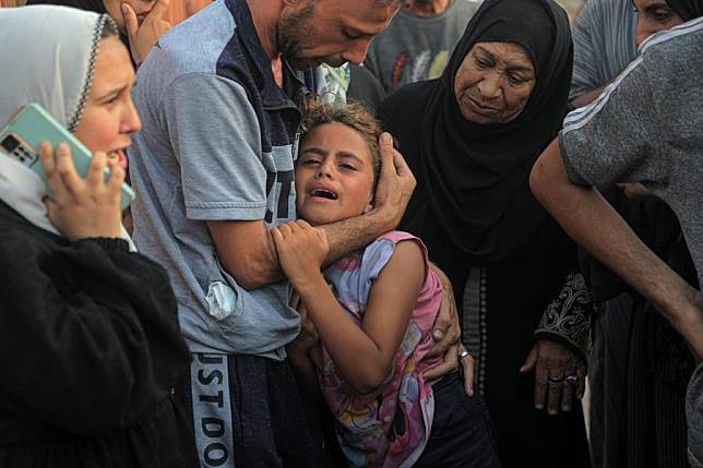 A girl grieves over victims killed in Israeli attacks at the Nasser Medical Hospital in the southern Gaza Strip city of Khan Younis, on June 21, 2024. (Photo by Rizek Abdeljawad/Xinhua)