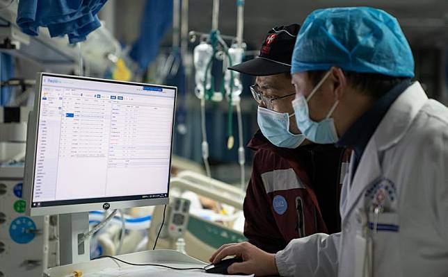 A medical worker from West China Hospital of Sichuan University (L) and a local doctor check the clinical data of a resident injured in the earthquake at the Xigaze People's Hospital in Xigaze City, southwest China's Xizang Autonomous Region, Jan. 7, 2025. (Xinhua/Tenzin Nyida)