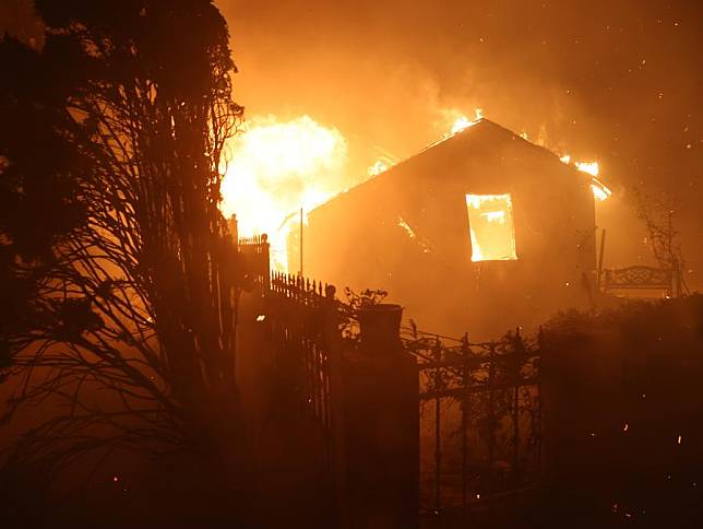 A house is engulfed by the flames on the site of the Palisades fire in Pacific Palisades, Los Angeles County, California, the United States, on Jan. 7, 2025. (Photo by Qiu Chen/Xinhua)