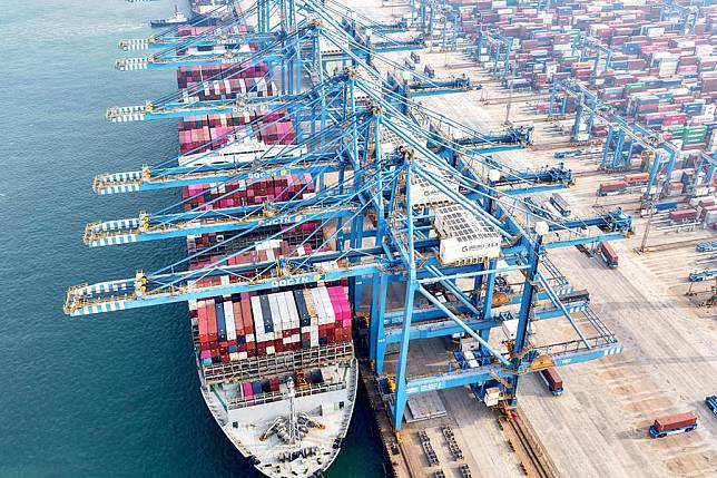 Containers are unloaded at Qingdao Port, east China's Shandong Province, Dec. 10, 2024. (Photo by Yu Fangping/Xinhua)