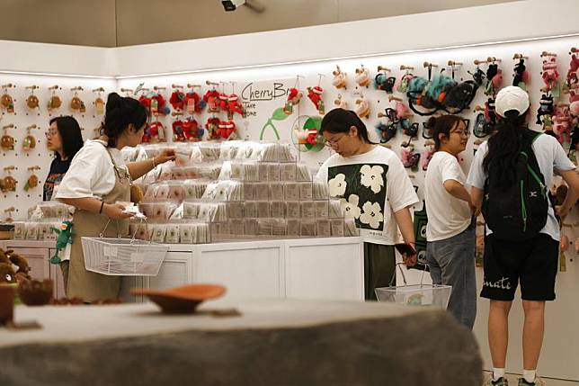 Visitors select cultural and creative products at the art and life gallery affiliated with the Gansu Provincial Museum in Lanzhou, northwest China's Gansu Province, June 13, 2024. (Xinhua/Ma Sha)