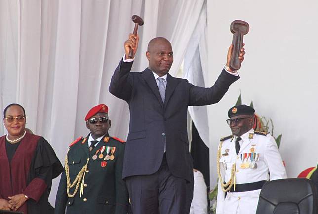 The newly sworn-in President of Mozambique Daniel Francisco Chapo demonstrates the symbol of power he received from Lucia Ribeiro, president of the Constitutional Council, during an inauguration ceremony in Maputo, Mozambique, on Jan. 15, 2025. (AIM/Handout via Xinhua)