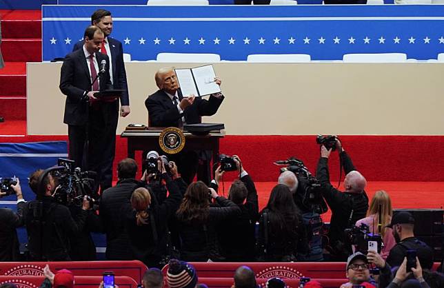 U.S. President Donald Trump shows an executive order he signed at Capital One arena in Washington, D.C., the United States, Jan. 20, 2025. (Xinhua/Wu Xiaoling)