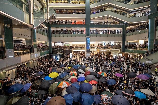 Demonstrators gather in the atrium of the New Town Plaza shopping mall on Sunday night. Photo: Bloomberg