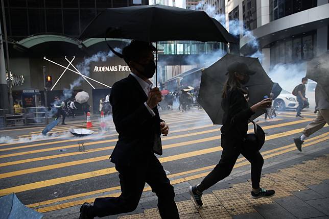 Riot police fire tear gas at Pedder Street in Central, after some protesters threw objects in the direction of officers on Monday. Photo: Winson Wong