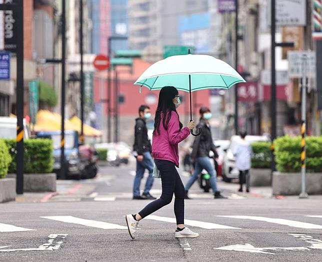 中央氣象局9日表示，西半部一整天斷斷續續有陣雨或雷雨；氣溫方面，北台灣感受舒適稍涼。圖為9日台北市中正區民眾撐傘走在細雨街頭。中央社記者王飛華攝 111年6月9日  
