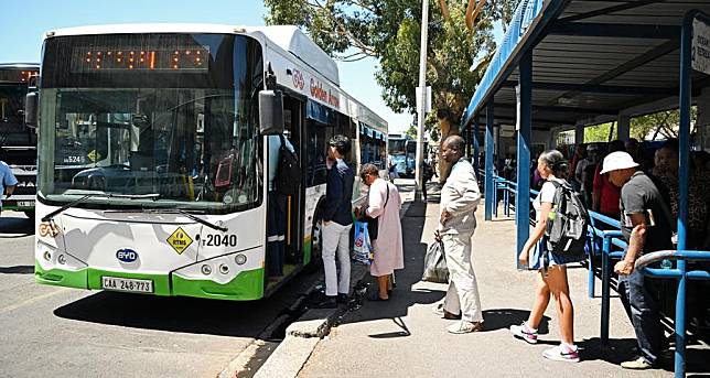 People wait to board a BYD electric bus in Cape Town, South Africa, Feb. 28, 2024. China-made electric buses have been incorporated into the day-to-day operations of Golden Arrow Bus Services here. (Photo by Xabiso Mkhabela/Xinhua)