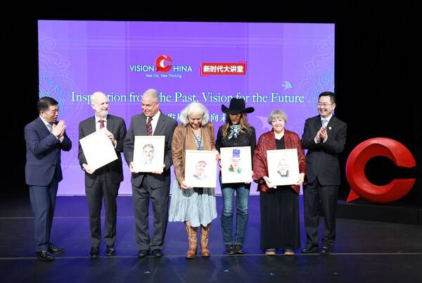 Qu Yingpu (right), publisher and editor-in-chief of China Daily; Hu Wei (left), president and CEO of Bank of China USA, and guest speakers holding their souvenir portraits pose for a photo at the Vision China event in New York on Thursday. FENG YONGBIN / CHINA DAILY