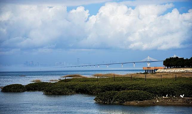 This photo taken on Feb. 21, 2024 shows the Kinmen bridge and a view of Xiamen in the distance seen from an estuary in Kinmen. (Xinhua/Chen Jianxing)