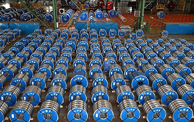 A staff member works at a warehouse of Shougang Jingtang United Iron &amp; Steel Co., Ltd. in Tangshan, north China's Hebei Province, July 22, 2023. (Xinhua/Zhu Xudong)