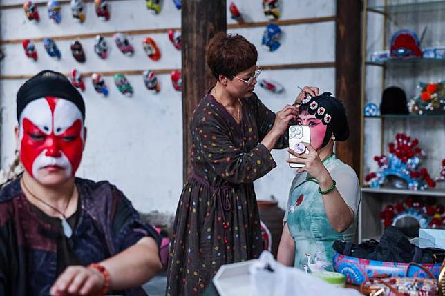 Artists from a local folk troupe of Wu Opera prepare for a performance in Zhengdian Village of Lipu Town, Jinhua City, east China's Zhejiang Province, June 25, 2024. (Xinhua/Xu Yu)