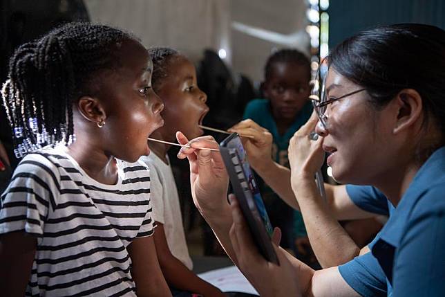 Members of the Chinese medical team conduct oral examinations for children at the Frans Nambinga Arts and Training Center in Windhoek, Namibia, Nov. 20, 2024. (Xinhua/Chen Cheng)