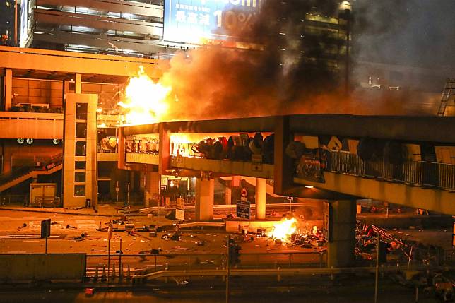 Fire breaks out during clashes between riot police and protesting students next to Hong Kong’s Polytechnic University on Sunday night. Photo: Winson Wong