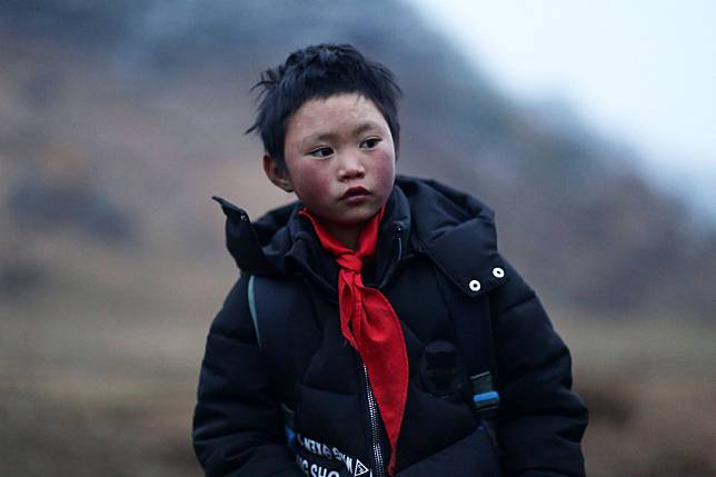 Nine-year-old Wang Fuman’s family has now moved from their mud hut to a two-storey home. Photo: AFP