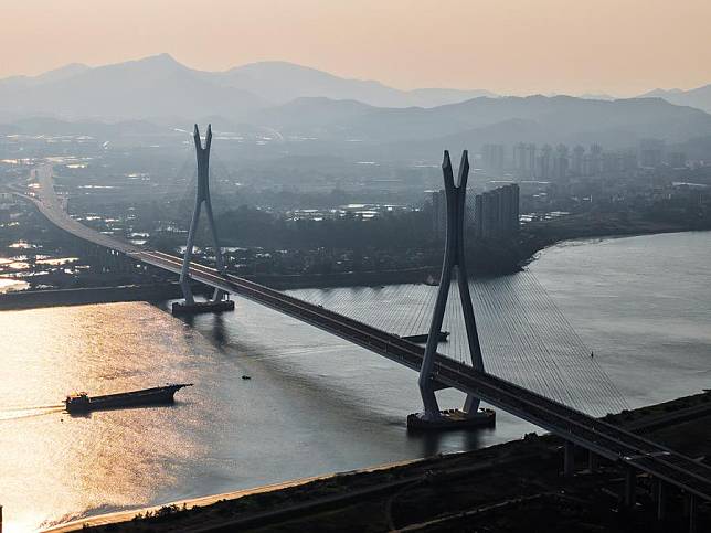 An aerial drone photo taken on Nov. 21, 2024 shows a view of the Fulong Xijiang super major bridge in Foshan, south China's Guangdong Province. Lying in Foshan City, the 1,770.6-meter-long bridge connects Gaoming District in the west and Sanshui District in the east. The bridge will further improve the transportation system of the western area of Guangzhou and Foshan in south China's Guangdong Province. (Xinhua/Liu Dawei)