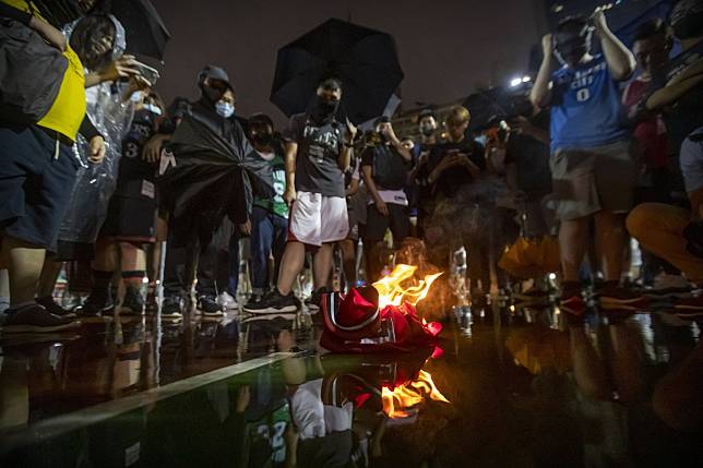 Protesters at the Southorn Playground in Hong Kong burn LeBron James jerseys on Tuesday after the NBA superstar called out Houston Rockets general manager Daryl Morey for backing the Hong Kong protesters. Photo: AP