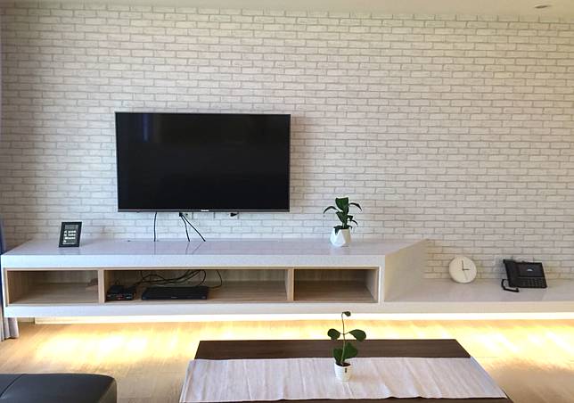
          <ul> <li>TV牆面使用文化石壁紙，讓空間添加了溫度，懸吊的TV櫃下面搭配的間接燈光，讓看似沉重的人造石檯面更顯輕盈。</li> <li><br></li> </ul><p><br></p><br  /> Credits: homify / <a href=