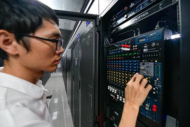 A staff member checks the operation of devices at the State Key Laboratory of Public Big Data at Guizhou University in Guiyang, southwest China's Guizhou Province, Aug. 29, 2024. (Xinhua/Yang Wenbin)