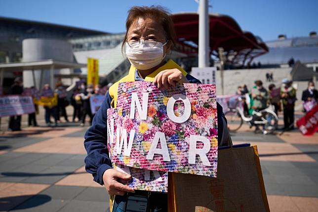 A woman protests in front of the convention center of Makuhari Messe in Chiba Prefecture, Japan, March 15, 2023. (Xinhua/Zhang Xiaoyu)