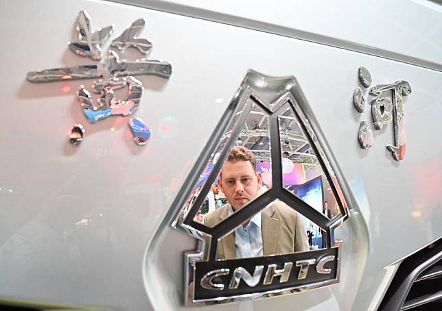 A man looks at a hydrogen fuel tractor at the booth of Chinese truck manufacturer Sinotruk during the International Motor Show (IAA) Transportation 2024 in Hannover, Germany, Sept. 17, 2024. (Xinhua/Ren Pengfei)