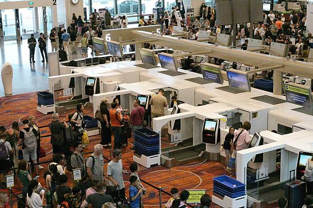 Long queues of passengers are seen in front of check-in counters in Singapore's Changi Airport on July 19, 2024. (Photo by Then Chih Wey/Xinhua)