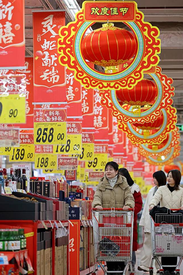 Customers select products at a supermarket in Zaozhuang, east China's Shandong Province, Jan. 9, 2025. (Photo by Sun Zhongzhe/Xinhua)