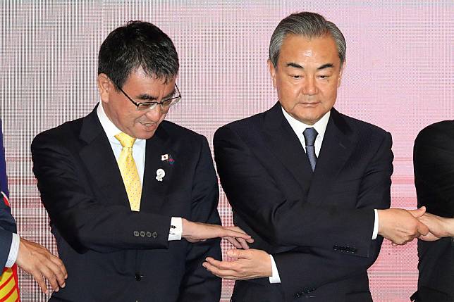 Chinese Foreign Minister Wang Yi (right) may seek to ease tensions when he meets Taro Kono (left) and Kang Kyung-wha. Photo: Reuters