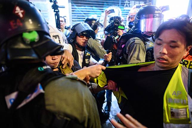 A video journalist (at right) during a protest in Causeway Bay, Hong Kong on September 8. Photo: AFP