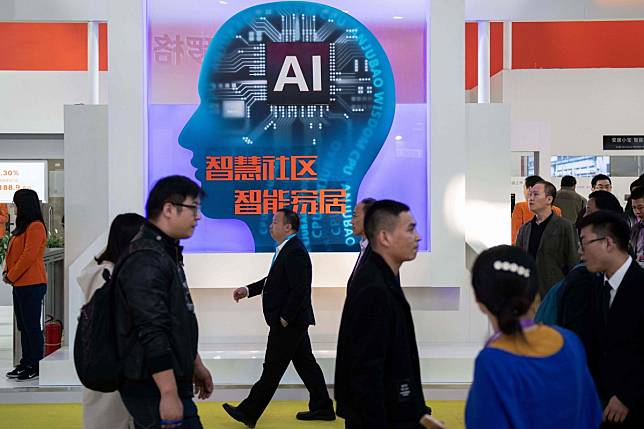Visitors walk past a stand with artificial intelligence cameras at the 14th China International Exhibition on Public Safety and Security in Beijing on October 24. Photo: Agence France-Presse