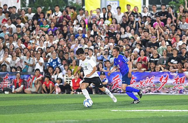 A player of team Rongjiang County (L) vies with a player of team Guoluo Tibetan Autonomous Prefecture during their friendly match of &ldquo;Village Super League&rdquo; in Rongjiang County of southwest China's Guizhou Province, June 23, 2023. (Xinhua/Yang Wenbin)