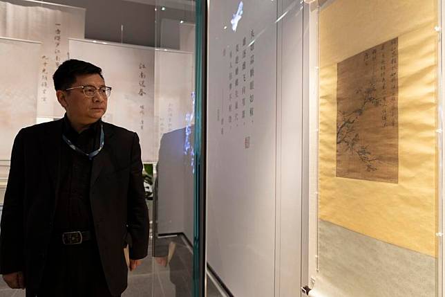 Ru Yuelai, curator of the Suzhou Bay Museum, prepares to introduce the painting “two sparrows on a tree” of Tang Yin, an ancient Chinese artist, at an exhibition in Suzhou Bay Museum in Suzhou, east China's Jiangsu Province, April 10, 2024. (Xinhua/Jin Liwang)