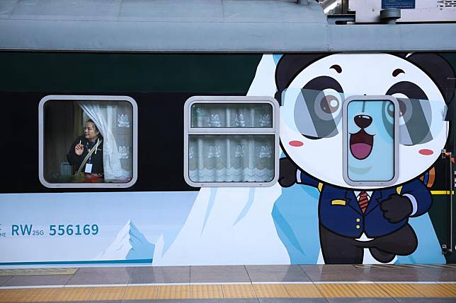 A passenger boards a “Panda Train” at Guiyang railway station in Guiyang, capital of southwest China's Guizhou Province, May 8, 2024.(Xinhua/Liu Xu)