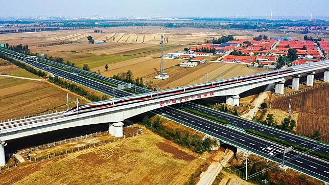 This photo taken on Oct. 21, 2024 shows a bullet train running past the Changping grand bridge of the Weifang-Yantai high-speed railway in east China's Shandong Province. (Photo by Zhang Wenliang/Xinhua)