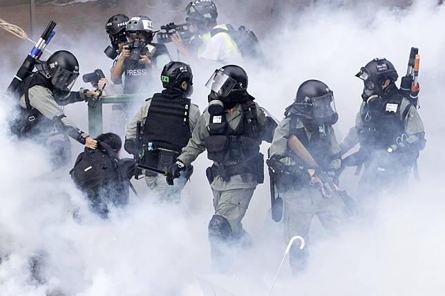 There were chaotic scenes when police made arrests at Polytechnic University in Hong Kong. The stand-off has continued long into Tuesday. Photo: AP