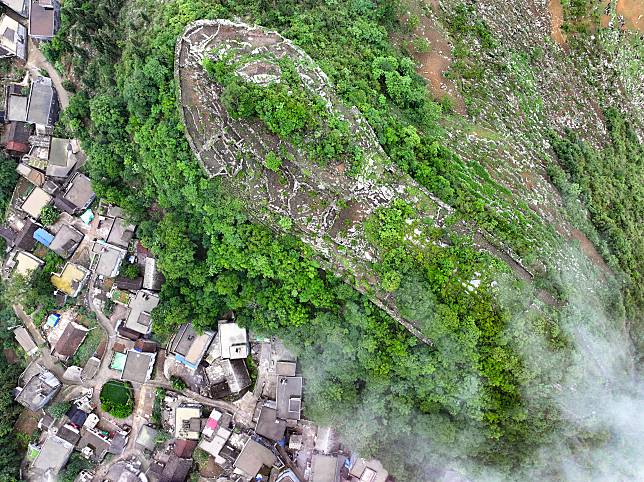 An aerial drone photo taken on May 17, 2024 shows a view of an ancient city ruin dating back to the Ming Dynasty (1368-1644) at Pingzhai Village of Bouyei-Miao Autonomous Prefecture of Qianxinan, southwest China's Guizhou Province. (Xinhua/Liu Xu)