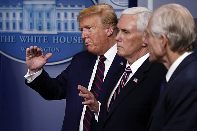 US President Donald Trump speaks about the coronavirus at the White House on Thursday, as Vice-President Mike Pence and White House trade adviser Peter Navarro, who also serves as the Defence Production Act coordinator, listen. Photo: AP