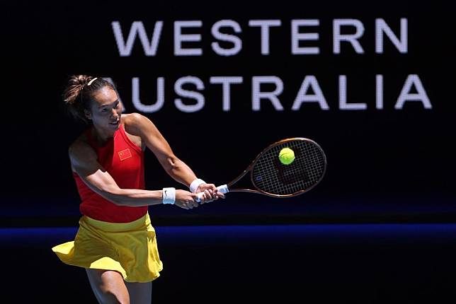 Zheng Qinwen of China hits a return during the women's singles match against Marketa Vondrousova of the Czech Republic at the 2024 United Cup Group E match in Perth, Australia, on Dec. 30, 2023. (Photo by Zhou Dan/Xinhua)