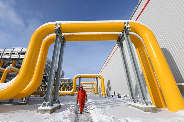 A worker walks under pipes in a section of the China-Russia natural gas pipeline in Heihe, in northeast China’s Heilongjiang Province Photo: Xinhua