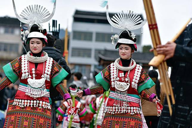 Twin sisters Yang Ningzhu (L) and Yang Ningyu perform Lusheng dance in celebration of Gannangxiang festival in Zhouxi Town of Kaili, Qiandongnan Miao and Dong Autonomous Prefecture, southwest China's Guizhou Province, Feb. 15, 2025. (Xinhua/Yang Wenbin)