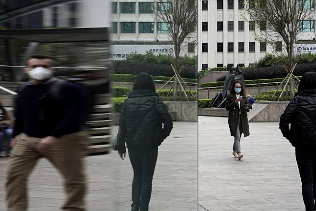 People wearing protective face masks walk along a street in Central, the business district of Hong Kong, on February 11. Long before the outbreak of the coronavirus, investors in Asian property were not being adequately compensated for the increased risks in the region. Photo: AP