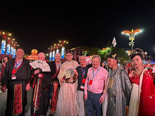 International tourists dressed in antique style Chinese attire pose for photos with Chinese tourists at the Grand Tang Mall, a bustling pedestrian area, in Xi'an, northwest China's Shaanxi Province, May 14, 2024. (Xinhua/Wang Jialin)