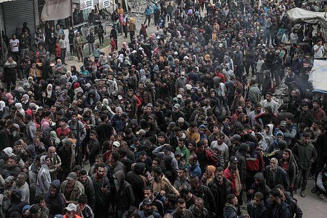 People wait to buy bread at a bakery in the southern Gaza Strip city of Khan Younis, on Nov. 18, 2024. (Photo by Rizek Abdeljawad/Xinhua)